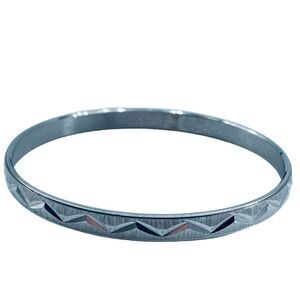 Vintage crown Trifari diamond cut silver colored bangle bracelet.